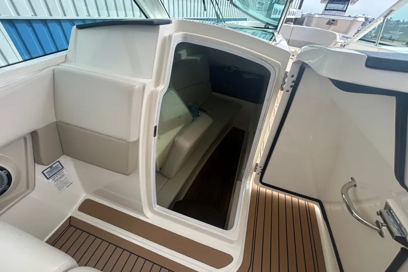 Slide: The Image of 2017 Boston Whaler 320 Vantage cabin interior with seating and wood flooring. - 35