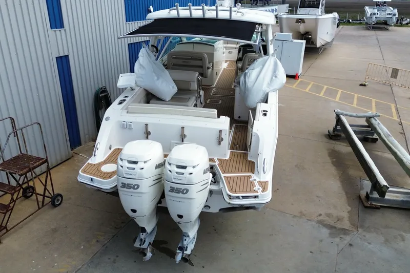Slide: The Image of 2017 Boston Whaler 320 Vantage boat with twin 350 engines, docked at a marina. - 4