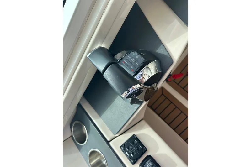 Slide: The Image of 2017 Boston Whaler 320 Vantage throttle controls and cup holders on deck. - 42