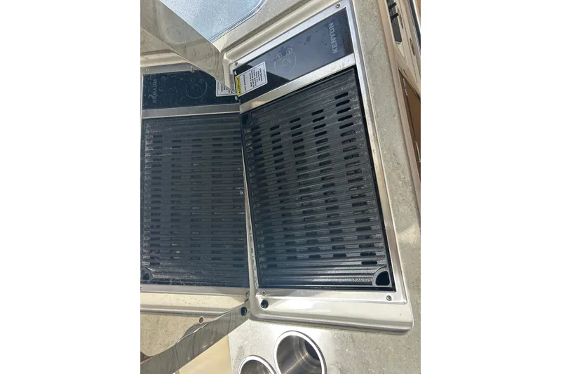 Slide: The Image of Built-in grill on 2017 Boston Whaler 320 Vantage boat, featuring Kenyon cooking surface. - 46