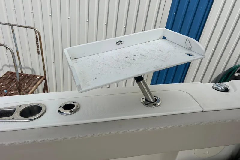 Slide: The Image of 2017 Boston Whaler 320 Vantage boat with a mounted white tray and rod holders. - 47