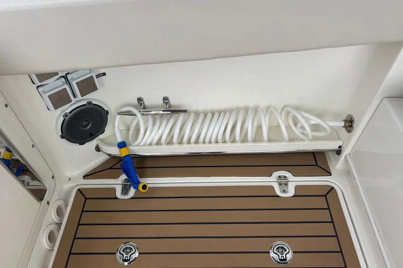 Slide: The Image of 2017 Boston Whaler 320 Vantage deck with coiled hose and speaker. - 48