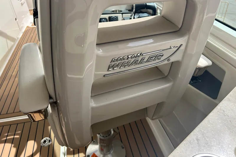 Slide: The Image of 2017 Boston Whaler 320 Vantage interior detail with logo and seating. - 50