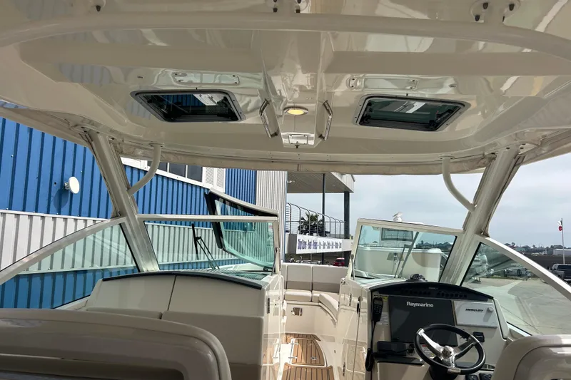 Slide: The Image of 2017 Boston Whaler 320 Vantage boat interior with helm and seating area. - 51