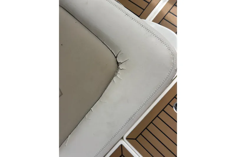 Slide: The Image of Cracked seat upholstery on 2017 Boston Whaler 320 Vantage boat, showing wear and tear. - 58