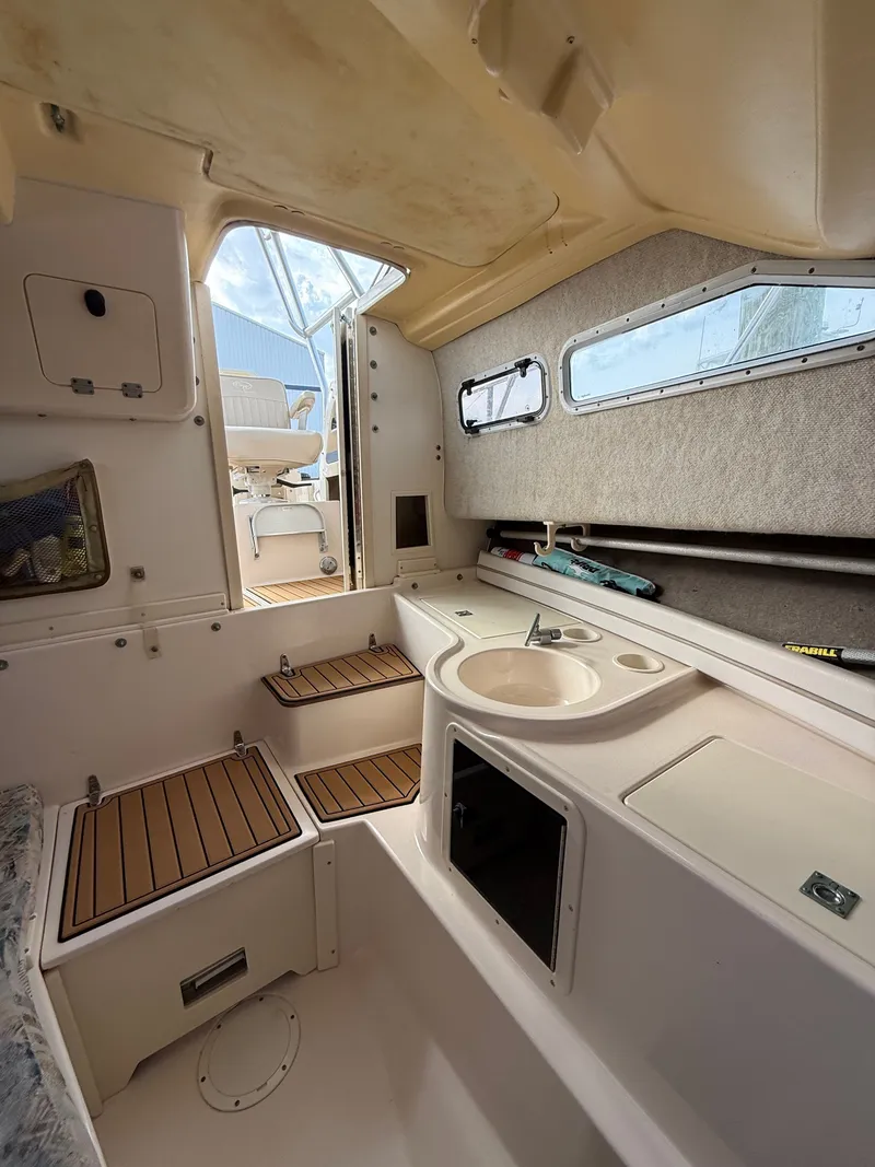 Slide: The Image of Interior of a 2001 Grady-White Gulfstream 232 boat with sink and seating area. - 16