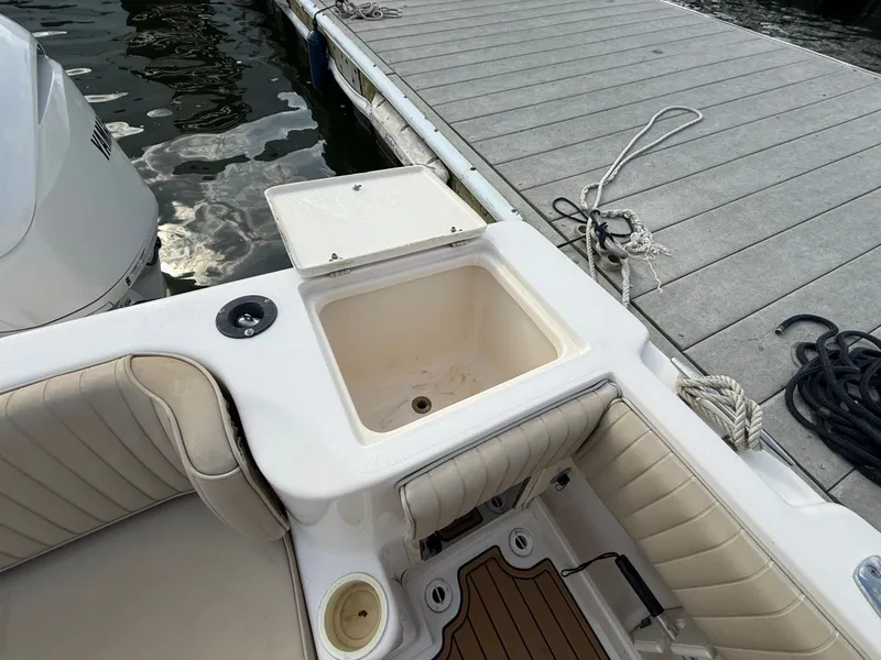 Slide: The Image of 2001 Grady-White Gulfstream 232 boat with seating and sink at dock. - 23