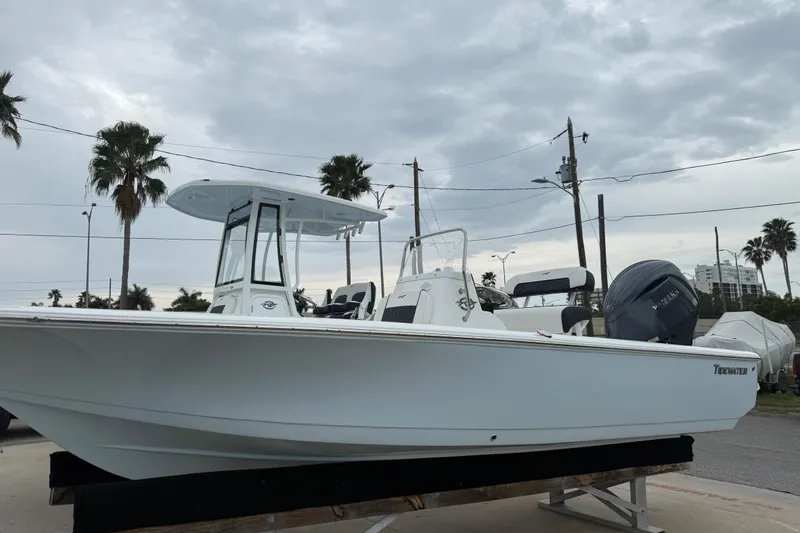 Slide: The Image of 2026 Tidewater 1910 Bay Max boat displayed outdoors under cloudy sky. - 10