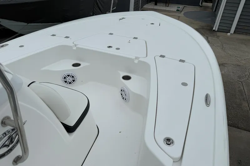 Slide: The Image of 2026 Tidewater 1910 Bay Max boat interior with white seating and storage compartments. - 2