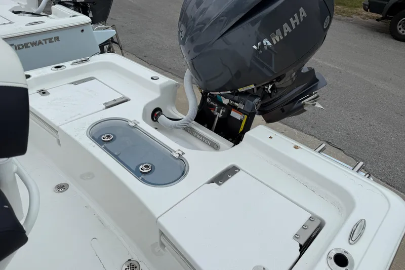 Slide: The Image of 2026 Tidewater 1910 Bay Max boat with Yamaha outboard motor, featuring storage compartments. - 6