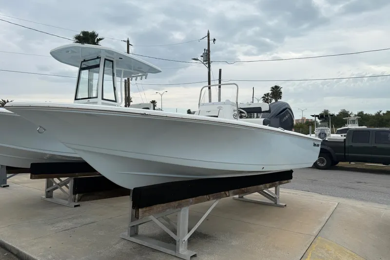 Slide: The Image of 2026 Tidewater 1910 Bay Max boat displayed on a stand outdoors. - 9