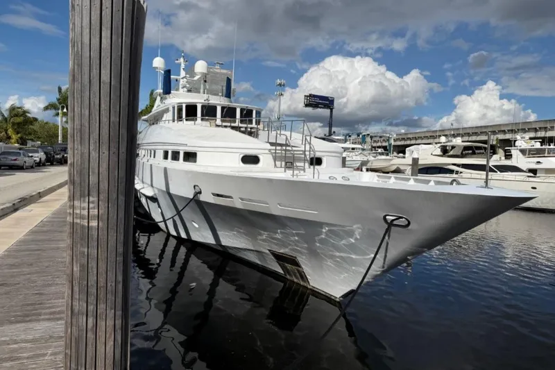 The Image of Luxury Heesen 144 yacht docked, 1990 model, under a partly cloudy sky. - 0