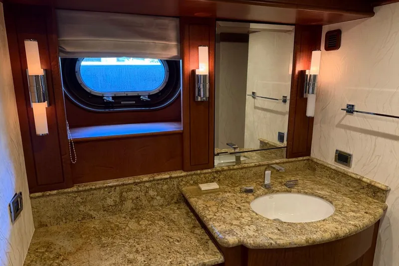 Slide: The Image of Luxurious yacht bathroom with granite countertop, mirror, and porthole window on a 1990 Heesen 144. - 100