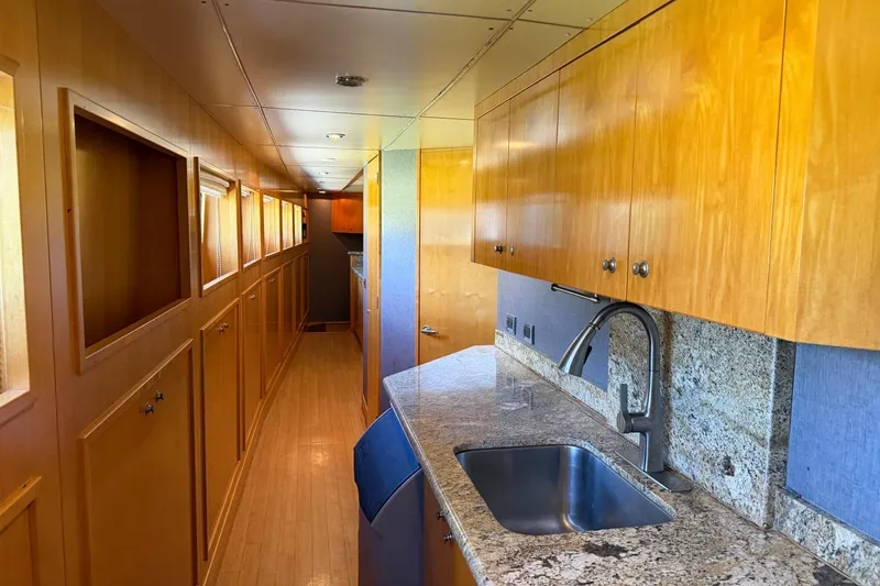 Slide: The Image of Luxurious Heesen 144 yacht interior with sleek wooden cabinetry and granite countertops, 1990 model. - 105