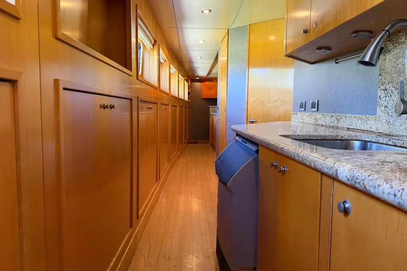 Slide: The Image of Luxurious wooden interior of 1990 Heesen 144 yacht with modern kitchen amenities. - 106