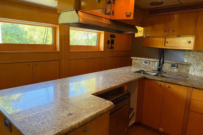 Slide: The Image of Luxurious kitchen interior of 1990 Heesen 144 yacht with granite countertops and wooden cabinetry. - 110