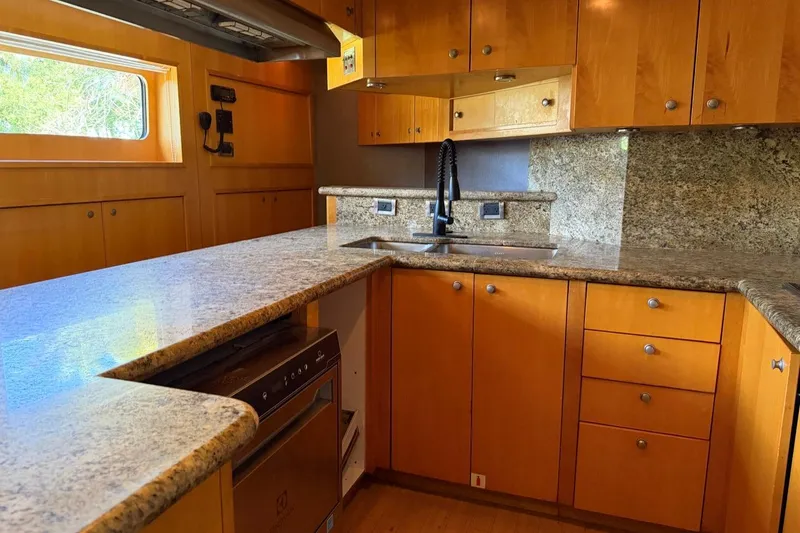 Slide: The Image of Luxurious yacht kitchen with granite countertops and wooden cabinets, Heesen 144, 1990 model. - 111