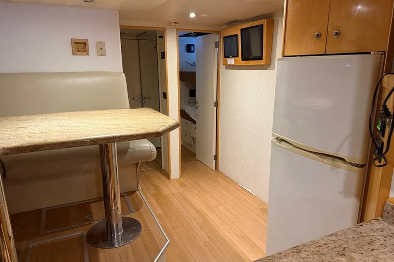 Slide: The Image of Interior of 1990 Heesen 144 yacht with dining area, fridge, and hallway view. - 113