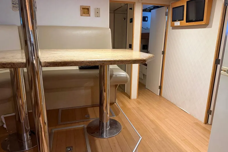 Slide: The Image of Interior of 1990 Heesen 144 yacht with modern seating and wooden flooring. - 114