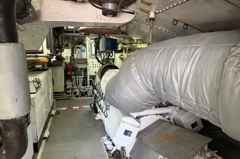 Slide: The Image of Engine room of a 1990 Heesen 144 yacht, featuring machinery and equipment. - 120
