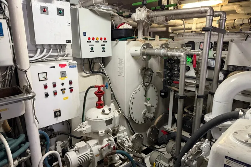Slide: The Image of Engine room of 1990 Heesen 144 yacht with control panels and piping systems. - 121