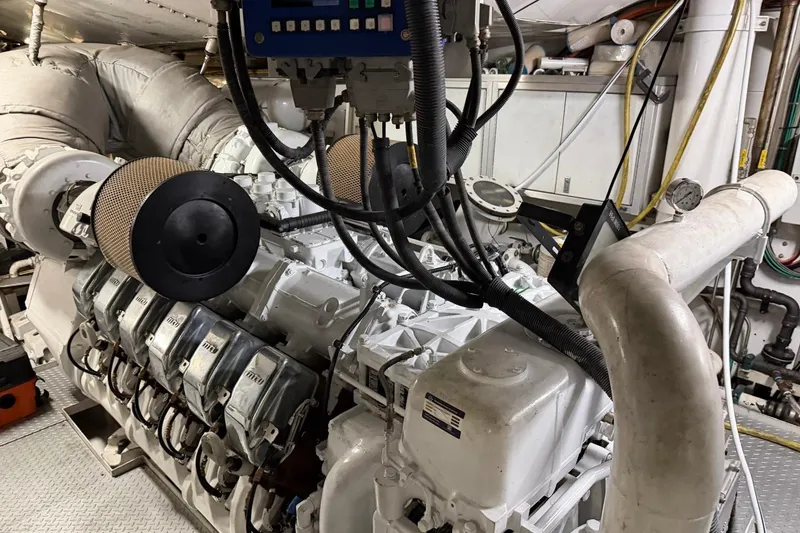 Slide: The Image of Engine room of a 1990 Heesen 144 yacht, showcasing complex machinery and piping. - 123