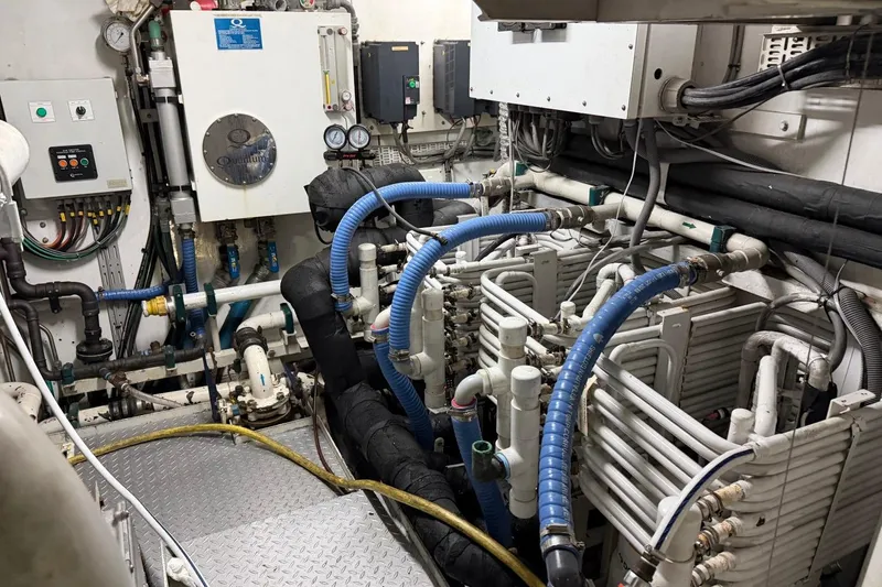 Slide: The Image of Engine room of a 1990 Heesen 144 yacht with complex piping and machinery. - 124