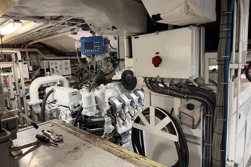 Slide: The Image of Engine room of a 1990 Heesen 144 yacht, featuring machinery and control panels. - 128