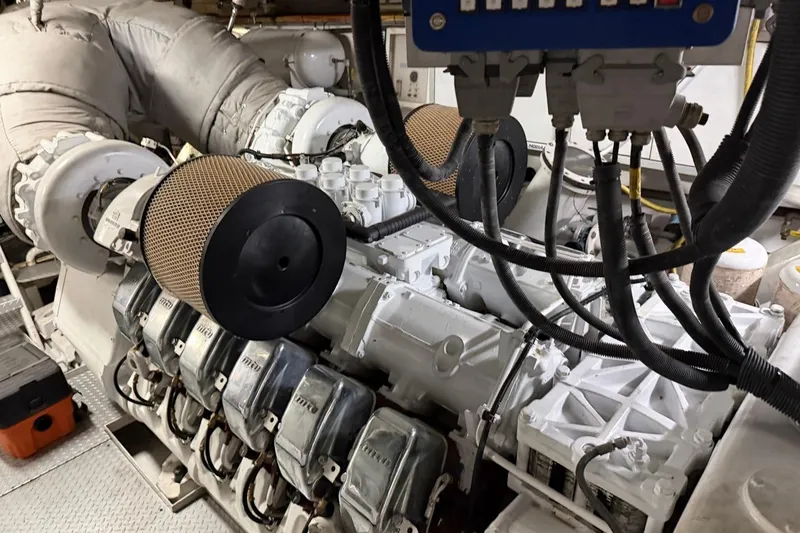 Slide: The Image of Engine room of a 1990 Heesen 144 yacht, showcasing complex machinery and components. - 129
