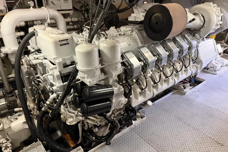 Slide: The Image of Engine room of a 1990 Heesen 144 yacht, showcasing a large marine engine. - 130