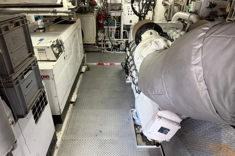 Slide: The Image of Engine room of a 1990 Heesen 144 yacht, featuring machinery and equipment. - 132