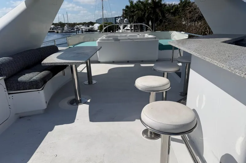Slide: The Image of Luxurious 1990 Heesen 144 yacht deck with seating, tables, and bar stools. - 21