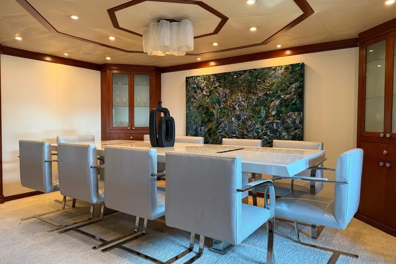 Slide: The Image of Luxurious dining area on 1990 Heesen 144 yacht with modern decor and elegant furnishings. - 32
