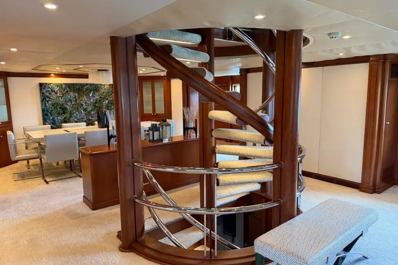 Slide: The Image of Luxurious Heesen 144 yacht interior with elegant spiral staircase and modern dining area, 1990 model. - 43