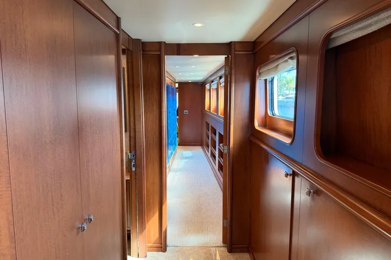 Slide: The Image of Luxurious wooden interior hallway of 1990 Heesen 144 yacht, featuring elegant design and windows. - 46