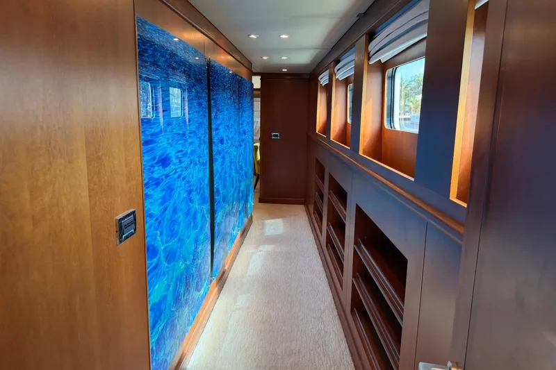 Slide: The Image of Luxurious hallway interior of 1990 Heesen 144 yacht with wood paneling and blue artwork. - 47