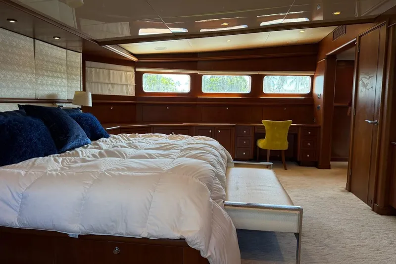 Slide: The Image of Luxurious bedroom interior on 1990 Heesen 144 yacht with elegant wood paneling and plush bedding. - 52