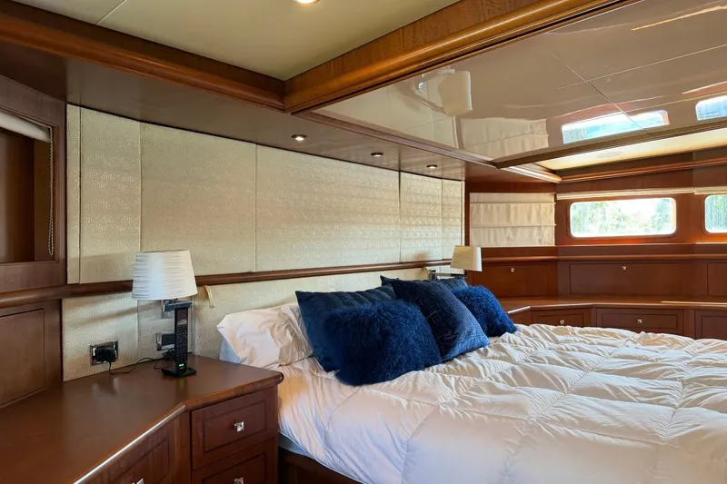 Slide: The Image of Luxurious bedroom interior on 1990 Heesen 144 yacht with elegant wood paneling and plush bedding. - 53
