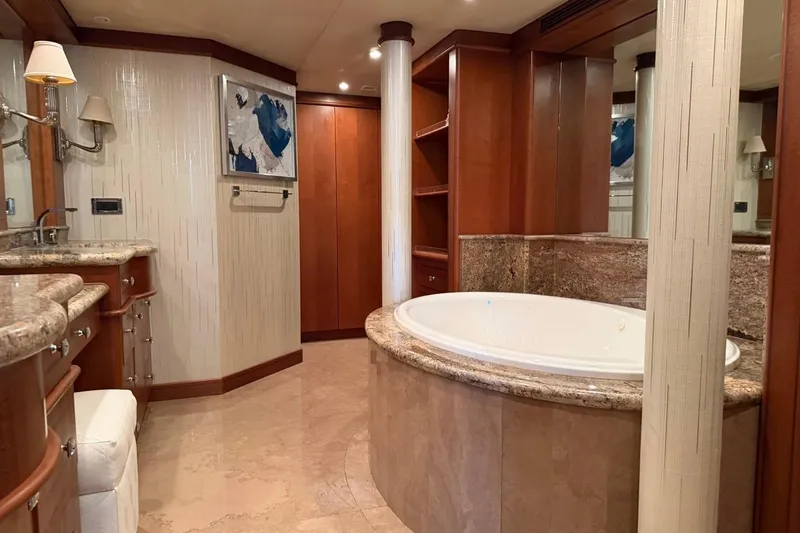 Slide: The Image of Luxurious yacht bathroom with marble tub, wooden cabinetry, and elegant lighting, Heesen 144, 1990 model. - 57