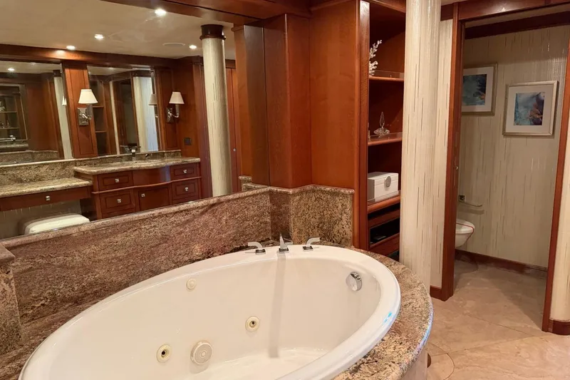 Slide: The Image of Luxurious bathroom with jacuzzi on 1990 Heesen 144 yacht, featuring elegant wood and marble finishes. - 59