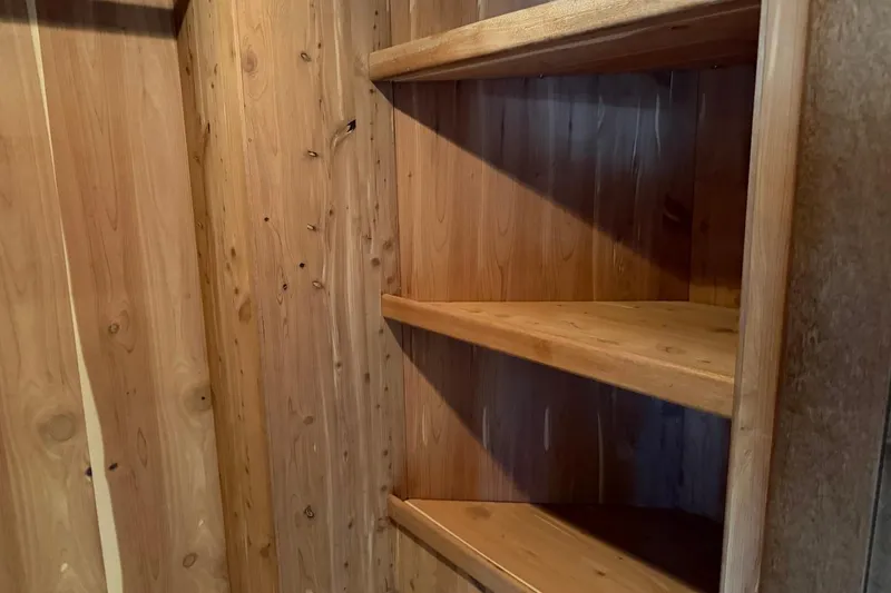 Slide: The Image of Wooden shelves in a Heesen 144 yacht, 1990 model, showcasing natural wood grain. - 61