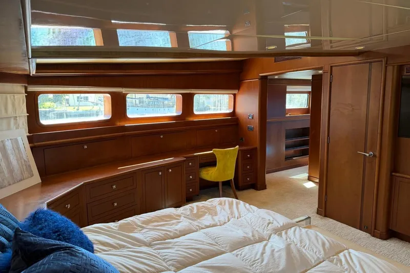 Slide: The Image of Luxurious Heesen 144 yacht interior, featuring elegant wood paneling and a cozy bedroom, built in 1990. - 64