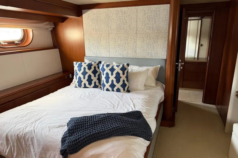 Slide: The Image of Luxurious bedroom interior on 1990 Heesen 144 yacht, featuring elegant wood paneling and stylish decor. - 65