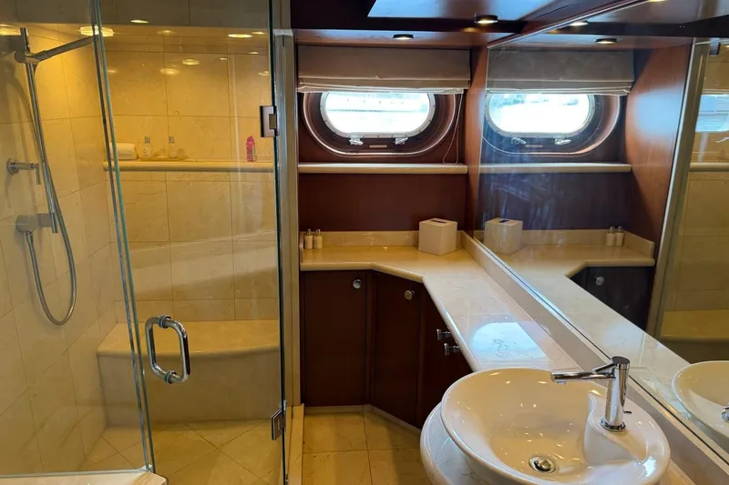 Slide: The Image of Luxurious yacht bathroom with glass shower, porthole windows, and elegant fixtures on Heesen 144, 1990. - 69