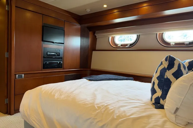 Slide: The Image of Luxurious Heesen 144 yacht bedroom interior with wood paneling and porthole windows, 1990 model. - 72