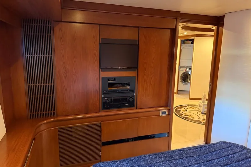 Slide: The Image of Luxurious Heesen 144 yacht interior with wood paneling, TV, and laundry area, built in 1990. - 78