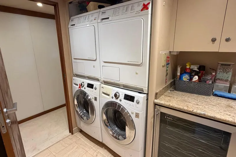 Slide: The Image of Laundry room with stacked washers and dryers on a 1990 Heesen 144 yacht. - 82