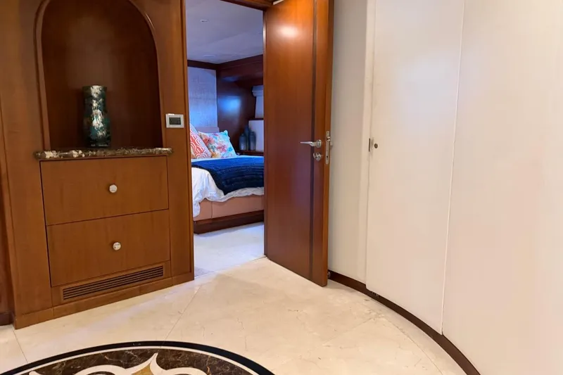 Slide: The Image of Luxurious Heesen 144 yacht interior, featuring elegant woodwork and a cozy bedroom, built in 1990. - 87