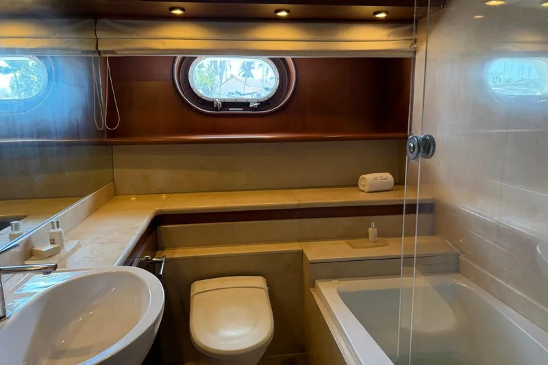 Slide: The Image of Luxurious bathroom interior on a 1990 Heesen 144 yacht, featuring elegant fixtures and porthole window. - 88