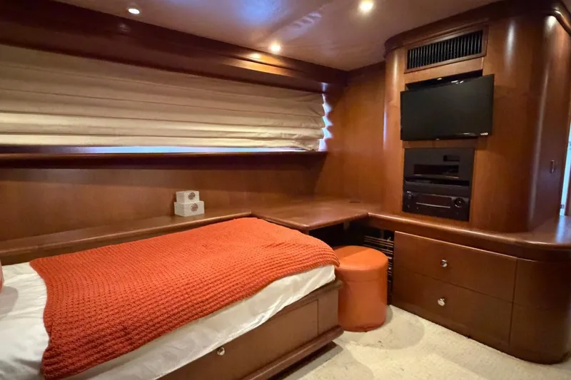 Slide: The Image of Luxurious Heesen 144 yacht bedroom, 1990 model, featuring wood paneling and modern entertainment system. - 90